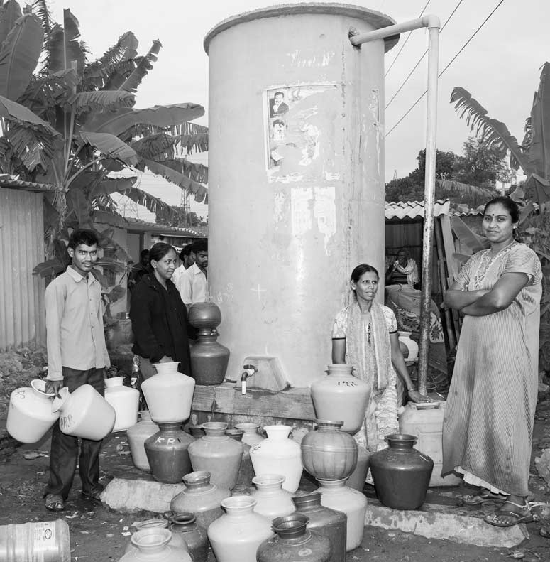 Women and men waiting for water at a public tapstand in an informal colony in Bengaluru, Karnataka